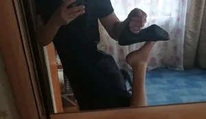 Girl Showing Her Feet while Taking Off High Heeled Shoe in front of the Mirror Selfie