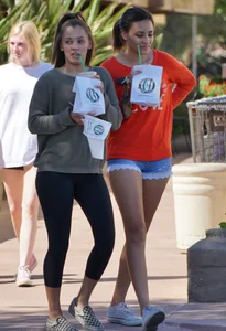 Brunette in tiny shorts walking with her sexy friend in leggings