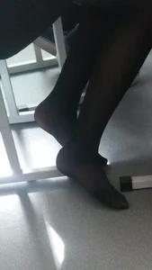 Slim Legs of a Teen College Girl At Her Desk With No Shoes On