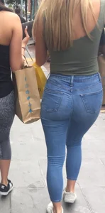 Sexy girl walking in grey patterned leggings with friend in tight jeans