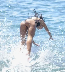 Awesome skinny candid girl in a swimsuit jumping into the water beach creepshot