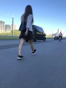 Extremely Cute Girl in a Skirt With a Backpack Passing By on the Street Gallery