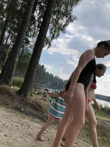 Cute Barefoot Girl in a Black Body Swimsuit Walking on a Road