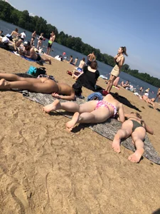 Gorgeous milf rubbing sun lotion in her skin at the beach, with a couple of her milf friends