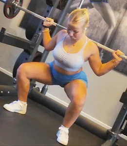 Small blonde pawg in light blue pants squatting as low as she can. Frontal view. OC