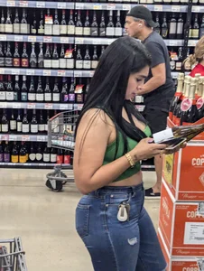 Sexy Latina buying wine
