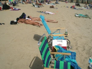 Milf laying out on a beach in Maine in her little thong