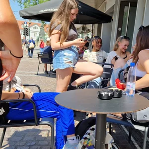 A Nice Candid Girl in a Top And Denim Shorts Hanging Out With Her Friends in a Street Cafe, Great Legs