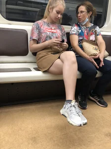 Amazing Hot Girl in a Skirt and Sneakers Sitting Cross-Legged in the Subway Train and on the Escalator Candid Photos Gallery