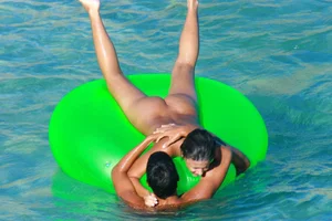 FKK Nudists playing in the water with floater