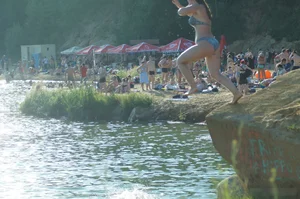 Chubby Girl in Swimsuit Jumping into Water on the Beach Candid