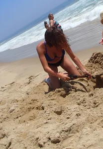 Girl with great tits playing in the sand at the beach