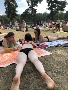 Pale Girl in Swimsuit Lying on a Lake Beach With Her Friends Creepshots Gallery