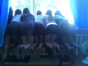 Girls in Skirts Standing on Knees on the Bench Candid Photo