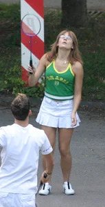Pretty girl playing tennis in a skirt and walking in jeans