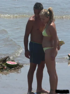 Sexy blonde on the beach in a yellow thong bikini