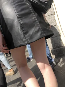 Hot redhead chick wearing leather skirt, nice pale legs