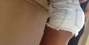 Sexy black girl in short white shorts