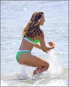 Super hot beach babe with a perfect body in a green thong bikini