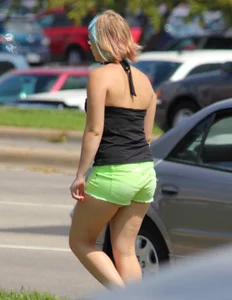 Blonde girl in glasses with a thick booty in green shorts