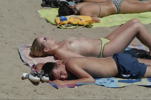 Girls on a nude beach in Sitges, Spain
