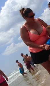 Thick lady on the beach with huge tits
