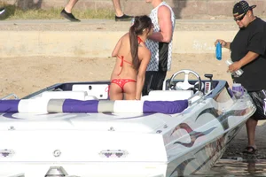Brunette on a boat in red thong bikini with a tight little ass