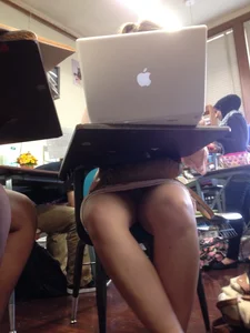 Candid Girl Sitting at a Desk in a Skirt Low Angle Legs Closeup