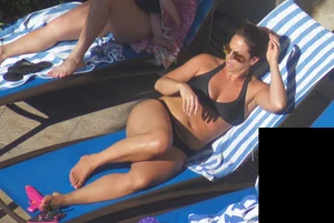 Milf laying out in black bikini by the pool