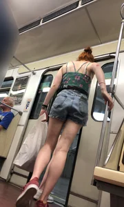Two Girls With Hot Long Legs in Mini Shorts and Sneakers in the Subway Train Candid Photo Gallery