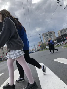 Candid teen girl wearing a skirt and white pantyhose crossing the street creepshots