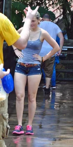 Cute blonde in denim shorts and a wet top
