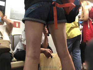 Girl in Shorts Standing in a Subway Train With Spread Legs - Creepshots Gallery