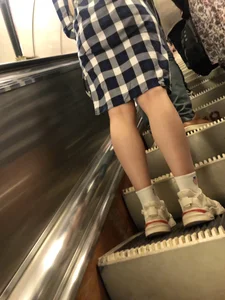 Fit Legs in White Socks and Sneakers on an Escalator Photos