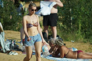 Girl in Swimsuit Top, Denim Shorts and Sunglasses Walking on the Beach Candid  Pics