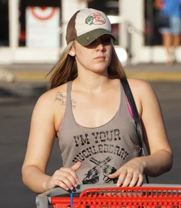 Hot blonde after shopping in short jean shorts and tank top