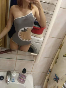 Girl in a Shark-like  Piece Swimsuit Home Mirror Selfie