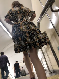 Low angle pics of a candid girl wearing a dress with long and very slim legs