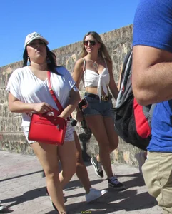 Three sexy friends in denim shorts and a skirt