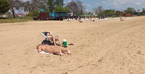 Girl laying out getting sun in a white thong bikini