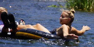 Sexy party girls in bikinis on a lake