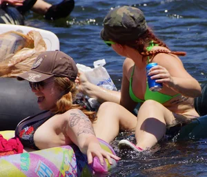 Sexy party girls in bikinis on a lake