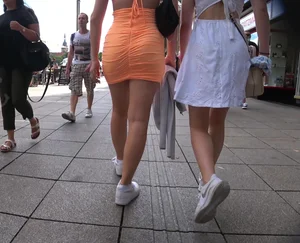 Sexy candid strawberry blonde chick in a tight orange dress with nice curves