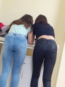 Two teens wearing tight jeans bending over creepshot