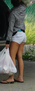 Girl next door teen neighbor bringing in groceries in short jean shorts