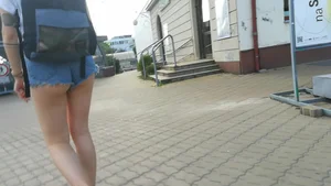 Girl walking in denim shorts showing some of her ass cheeks