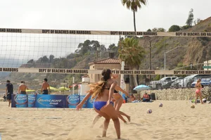 Sexy beach volleyball girl in sport bra top with pokies and blue bikini bottom