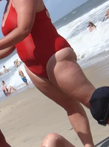Fat chick on the beach in a red swimsuit
