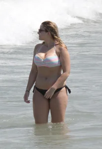 Big boobed thick blonde on the beach in a bikini