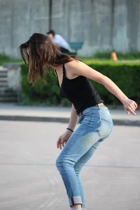 Hot brunette skateboarder in tight jeans and with hard nipples